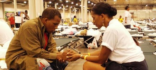 Offering comfort to a victim of hurricane Katrina, USA