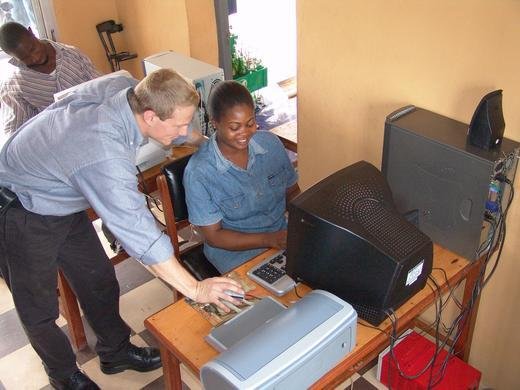 Josh teaches an attendee how to use a program